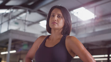 Portrait-Of-Smiling-Mature-Woman-Wearing-Fitness-Clothing-Standing-In-Gym-Ready-To-Exercise-1